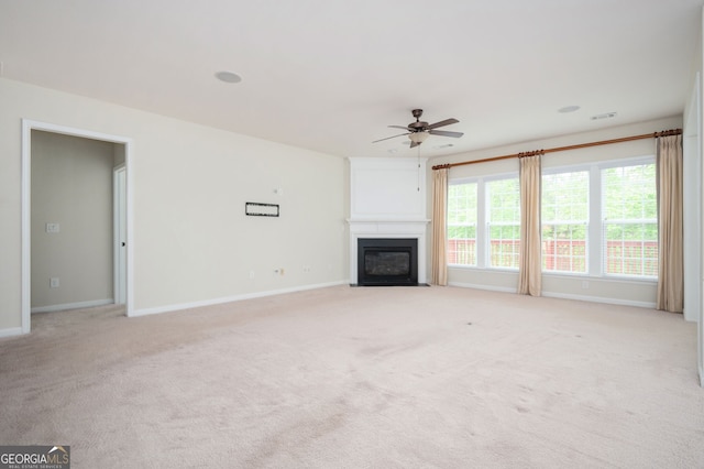 6732 Chimney Ridge Ct, Hoschton, GA 30548 - unfurnished living room featuring a ceiling fan, light carpet, and a fireplace with flush hearth