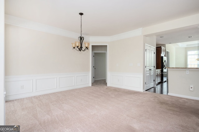 6732 Chimney Ridge Ct, Hoschton, GA 30548 - unfurnished room featuring a chandelier, carpet flooring, a wainscoted wall, ornamental molding, and a decorative wall