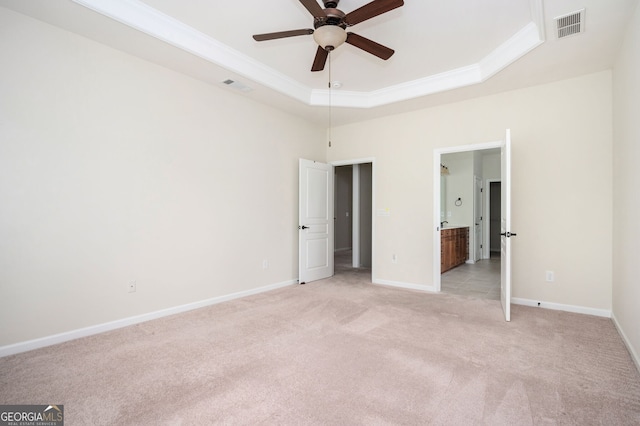6732 Chimney Ridge Ct, Hoschton, GA 30548 - unfurnished bedroom with light carpet, ornamental molding, a raised ceiling, and connected bathroom