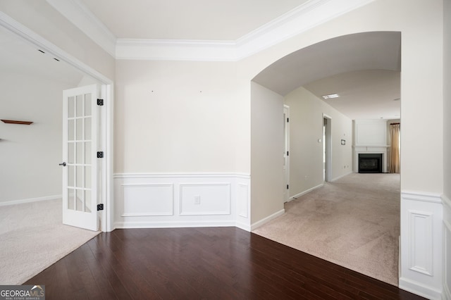 6732 Chimney Ridge Ct, Hoschton, GA 30548 - unfurnished room featuring a glass covered fireplace, arched walkways, carpet, hardwood / wood-style flooring, and ornamental molding