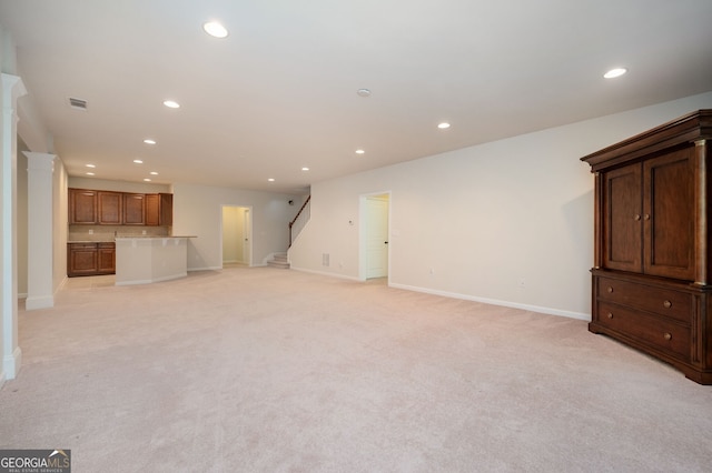 6732 Chimney Ridge Ct, Hoschton, GA 30548 - unfurnished living room with recessed lighting, stairway, and light colored carpet