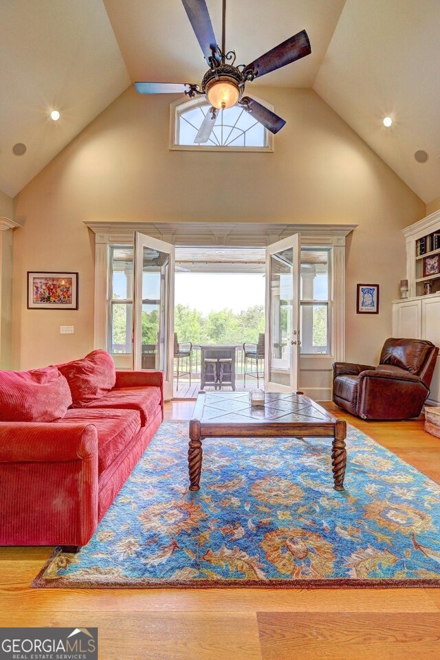living room with recessed lighting, high vaulted ceiling, ceiling fan, and wood finished floors