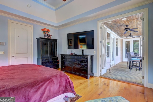 bedroom featuring wood-type flooring, access to outside, crown molding, and a raised ceiling