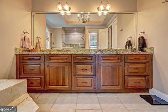 full bathroom with vanity, ornamental molding, tiled shower, tile patterned floors, and a chandelier
