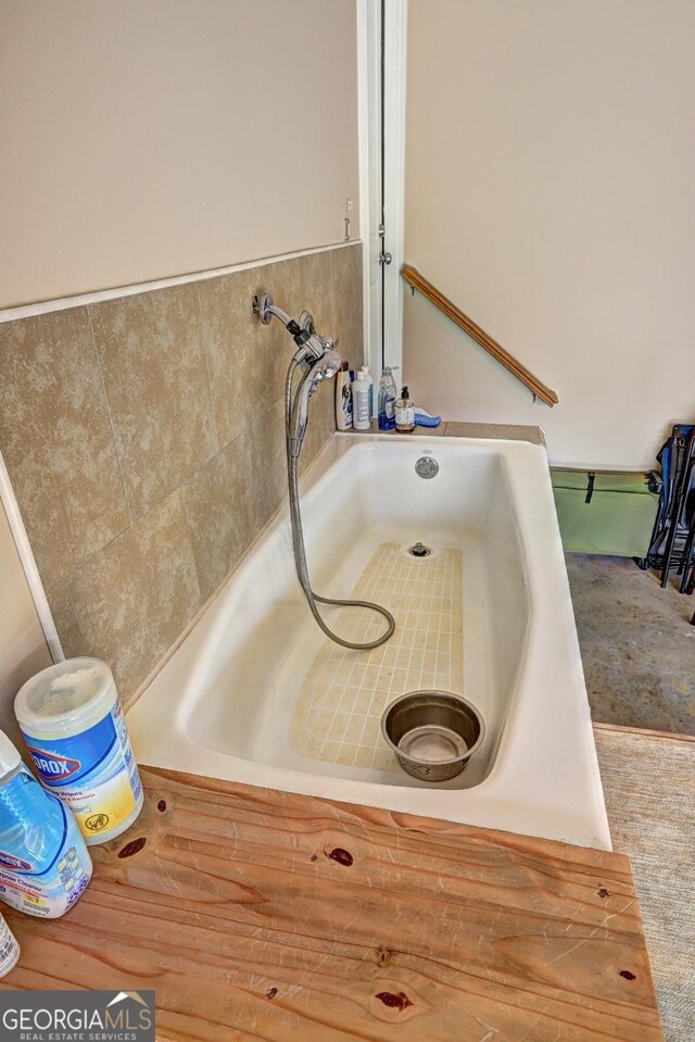 details featuring a sink and a tub to relax in