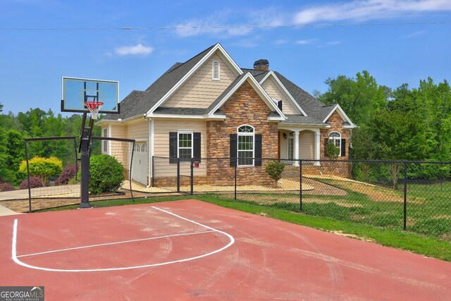 view of basketball court with fence, basketball court, and a gate