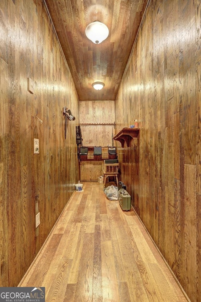 interior space featuring wood walls and light wood finished floors
