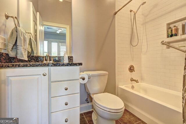 bathroom with tile patterned floors, baseboards, vanity, toilet, and tub / shower combination