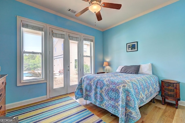 bedroom with crown molding, access to exterior, baseboards, wood finished floors, and visible vents