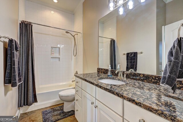 bathroom with toilet, tile patterned flooring, shower / tub combo, and vanity