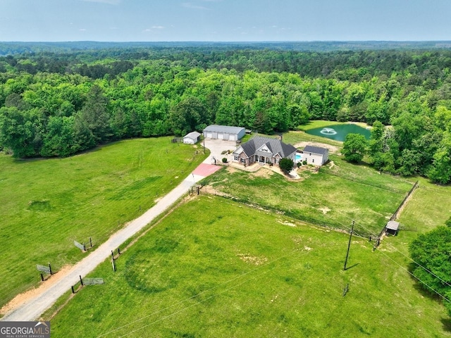birds eye view of property with a forest view
