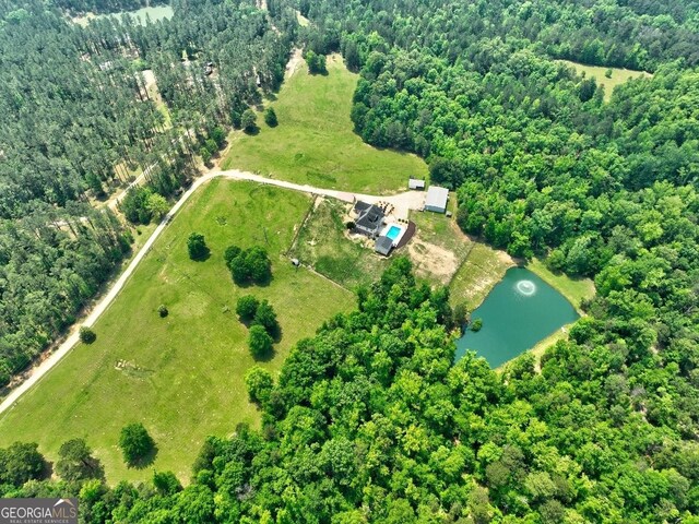 aerial view featuring a water view and a forest view