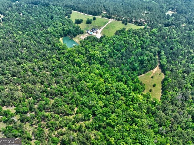 drone / aerial view with a wooded view