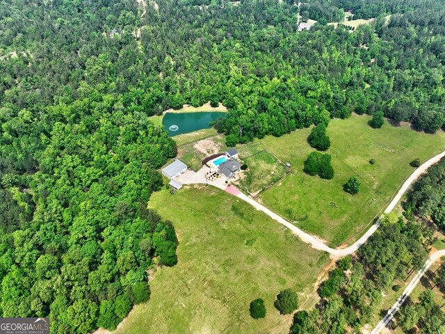 birds eye view of property featuring a wooded view