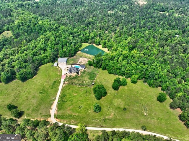 bird's eye view featuring a water view and a wooded view