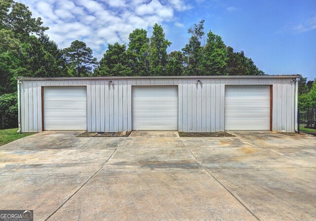 detached garage with concrete driveway