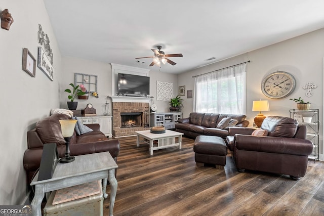 485 Lloyd St, Monticello, GA 31064 - living area with ceiling fan, dark wood-style floors, and a fireplace