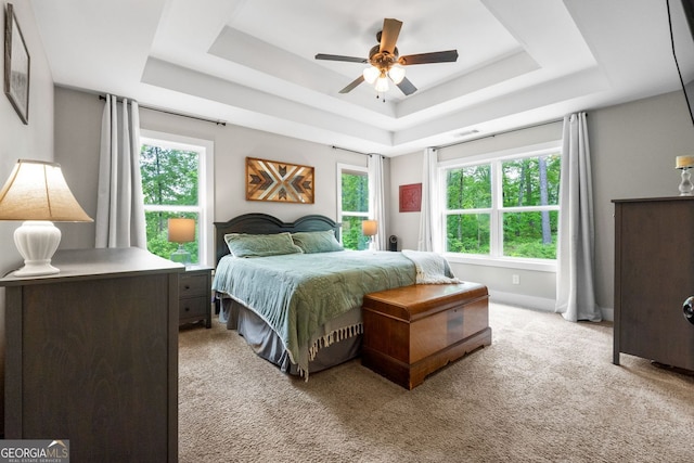 485 Lloyd St, Monticello, GA 31064 - bedroom featuring a tray ceiling, light carpet, baseboards, and a ceiling fan