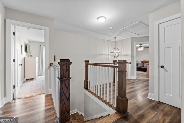 485 Lloyd St, Monticello, GA 31064 - hallway featuring an upstairs landing, attic access, dark wood-style floors, and baseboards