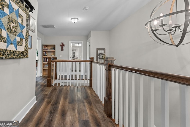 485 Lloyd St, Monticello, GA 31064 - hall featuring an upstairs landing, wood finished floors, a chandelier, and baseboards