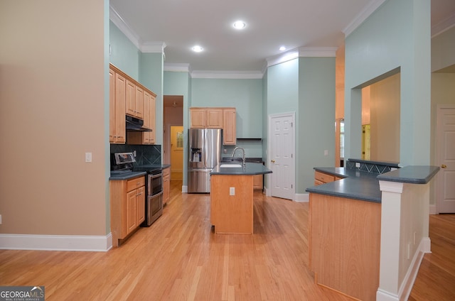 kitchen with dark countertops, range hood, a sink, ornamental molding, and stainless steel appliances