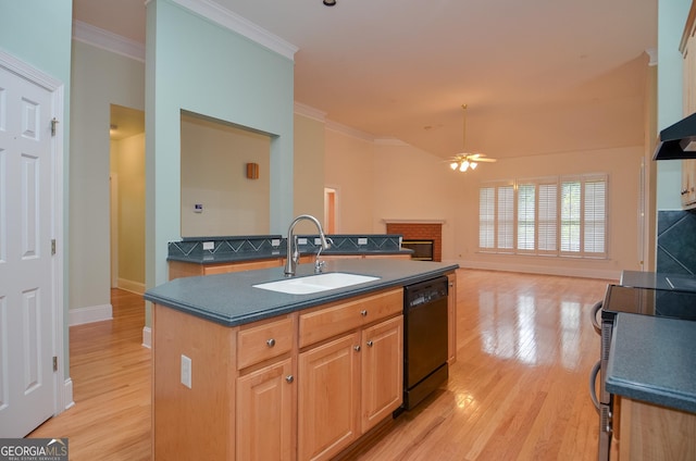 kitchen featuring ceiling fan, dark countertops, a sink, light wood-style floors, and black dishwasher