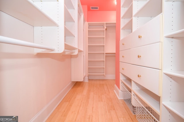 walk in closet featuring wood finished floors and visible vents