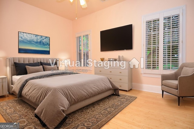 bedroom featuring baseboards and light wood-style flooring
