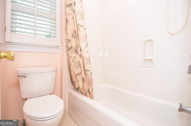 full bathroom featuring tile patterned flooring, shower / bathtub combination with curtain, and toilet