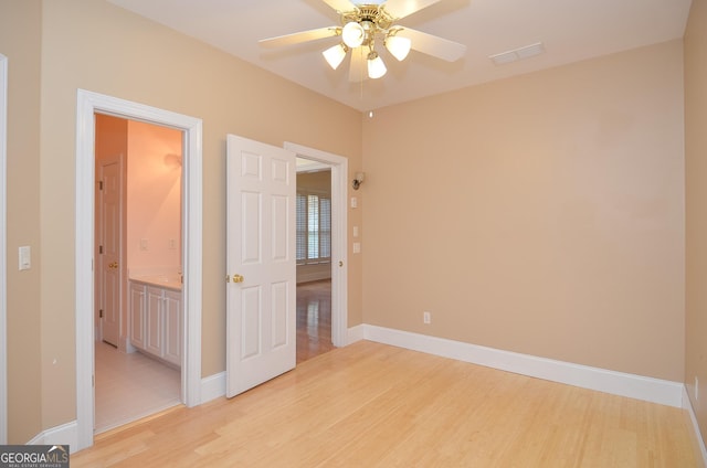unfurnished bedroom featuring a ceiling fan, baseboards, visible vents, and light wood-style flooring
