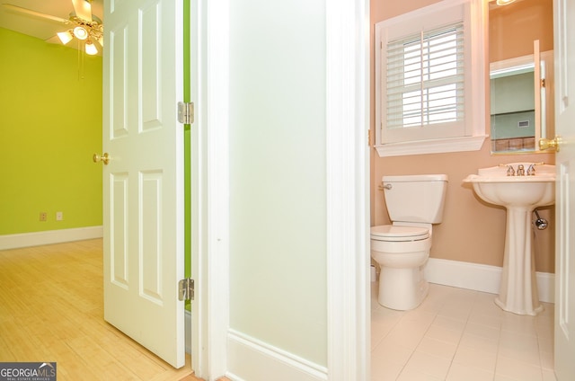 bathroom featuring baseboards, ceiling fan, toilet, and tile patterned flooring