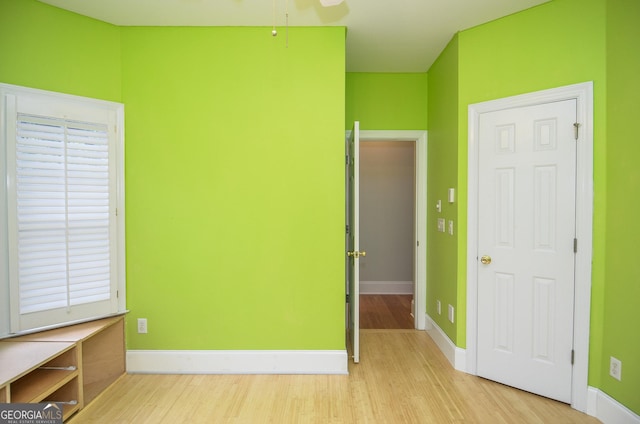unfurnished bedroom with baseboards and wood finished floors