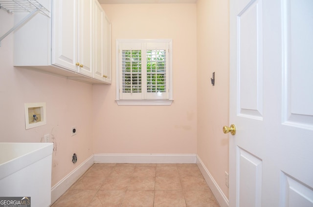 clothes washing area with baseboards, hookup for a washing machine, cabinet space, and hookup for an electric dryer