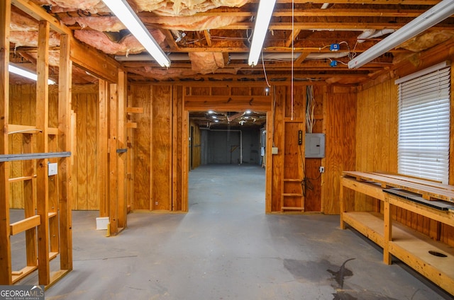 below grade area with electric panel and a workshop area