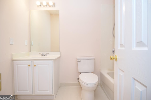 bathroom with vanity, baseboards, tile patterned flooring, and toilet
