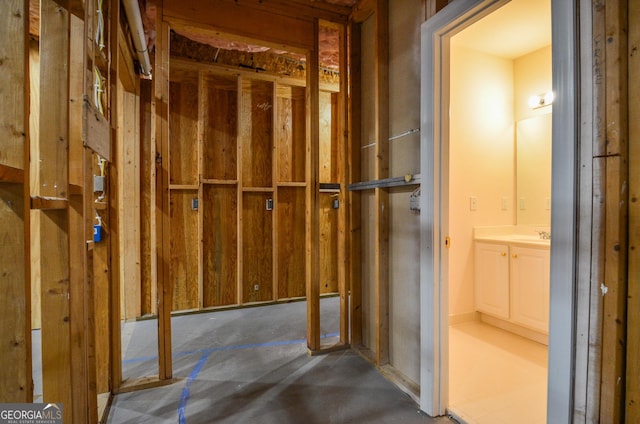 interior space with vanity and unfinished concrete flooring