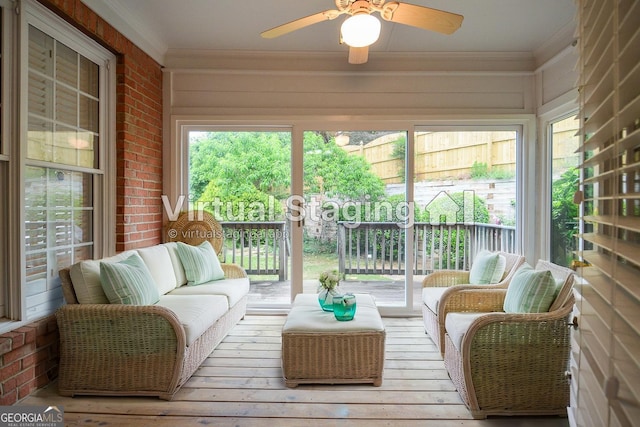 sunroom / solarium with an outdoor hangout area, a ceiling fan, crown molding, and hardwood / wood-style flooring