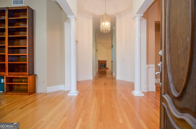 entryway with visible vents, baseboards, decorative columns, and light wood finished floors