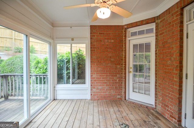 unfurnished sunroom featuring plenty of natural light and ceiling fan