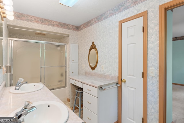 bathroom featuring double vanity, a sink, and wallpapered walls