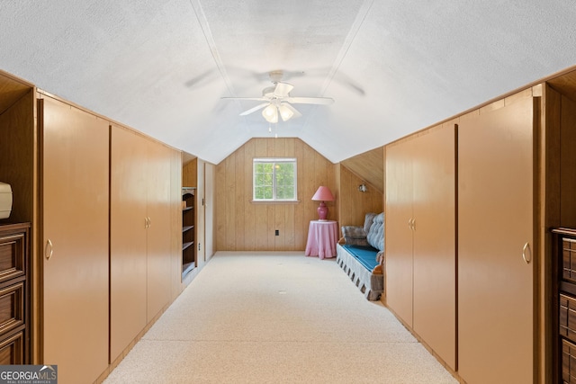 97 Kilmoore Ln, Hayesville, NC 28904 - carpeted bedroom featuring lofted ceiling, a textured ceiling, wooden walls, and ceiling fan