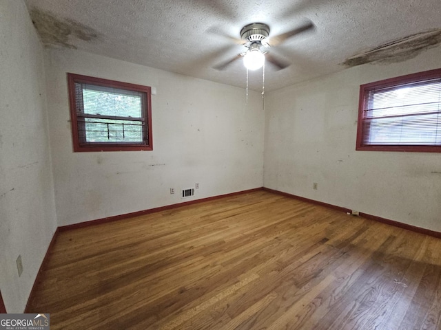1517 Colony E Cir, Stone Mountain, GA 30083 - spare room featuring visible vents, a textured ceiling, ceiling fan, and wood finished floors