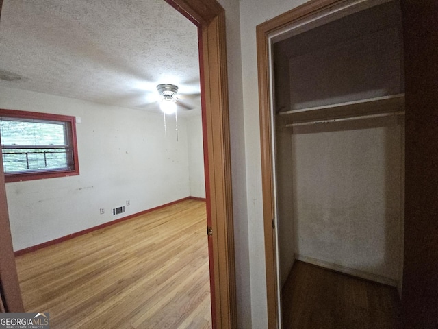 1517 Colony E Cir, Stone Mountain, GA 30083 - unfurnished bedroom featuring a textured ceiling, baseboards, wood finished floors, and visible vents