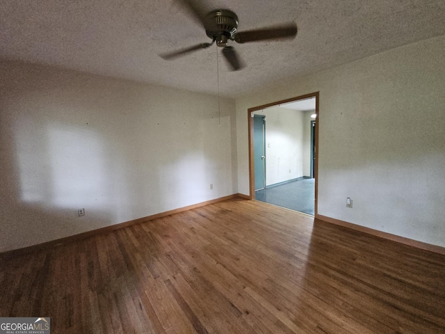 1517 Colony E Cir, Stone Mountain, GA 30083 - empty room featuring baseboards, a ceiling fan, a textured ceiling, and wood finished floors