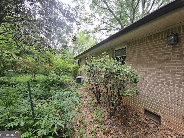 1517 Colony E Cir, Stone Mountain, GA 30083 - view of home's exterior featuring central AC unit, brick siding, and crawl space