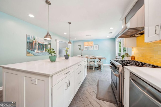 kitchen featuring light countertops, under cabinet range hood, white cabinets, tasteful backsplash, and stainless steel appliances