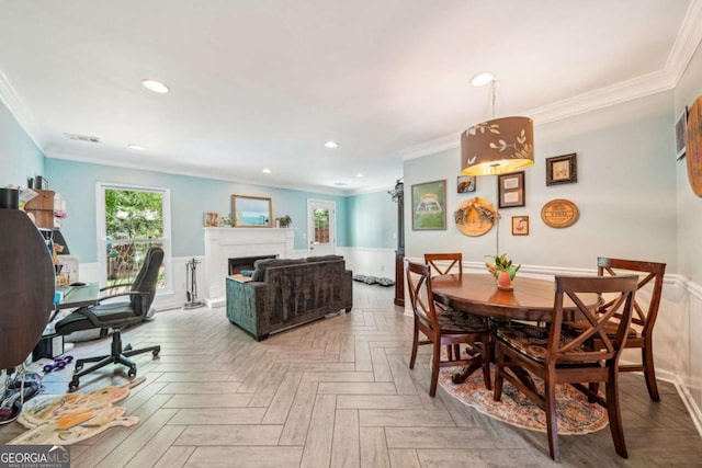 dining area featuring ornamental molding, wainscoting, and recessed lighting