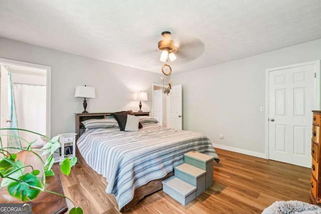 bedroom featuring baseboards, ceiling fan, and wood finished floors