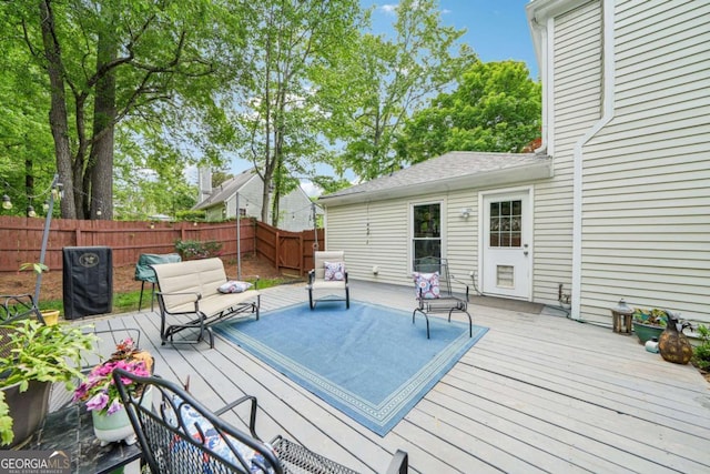 wooden deck featuring a fenced backyard