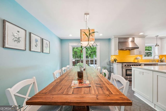 dining space featuring dark wood-style flooring, recessed lighting, and a wealth of natural light
